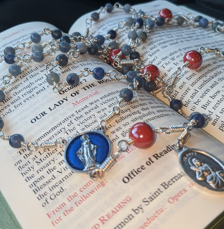 Our Lady of the Rosary with a breviary and wire-wrapped rosary
